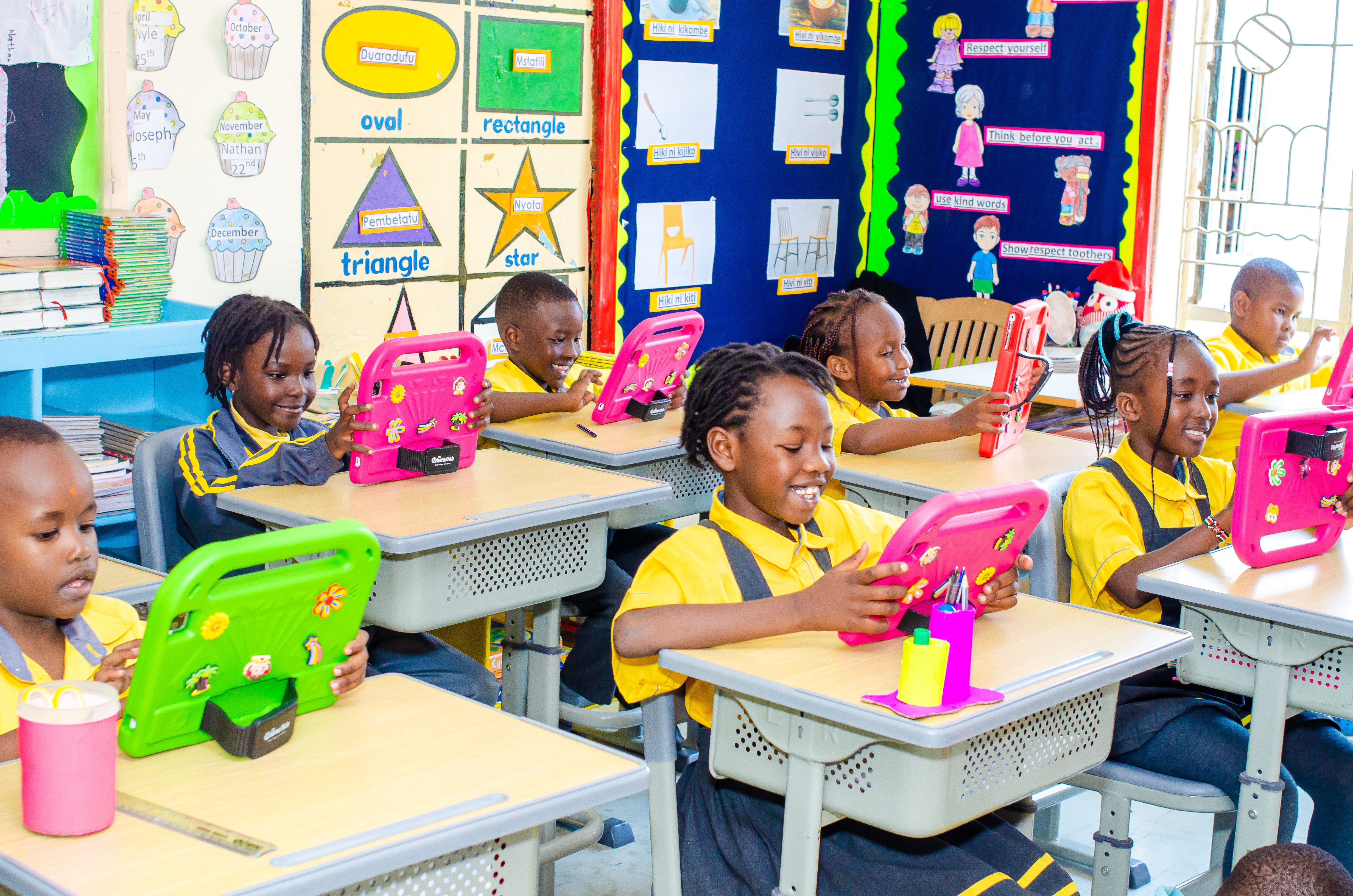 Happy preschoolers playing together in a classroom at Bloomsfield, Ruaka