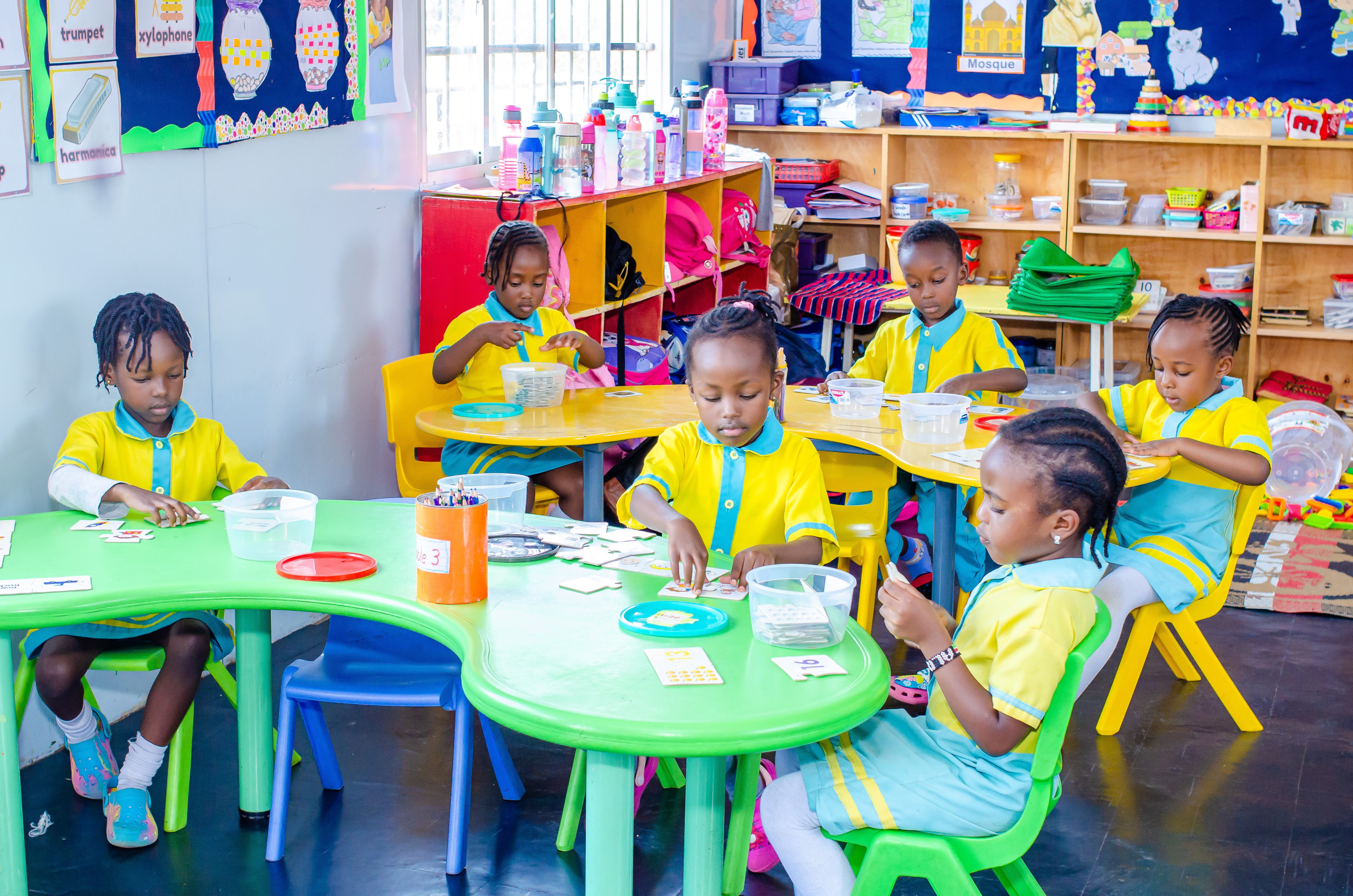 Young children drawing and painting in a bright classroom